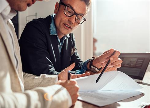 Businessman pointing place in contract where client have to sign Businessman pointing place in contract where client have to sign