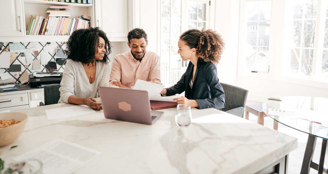 3 people having discussion near laptop