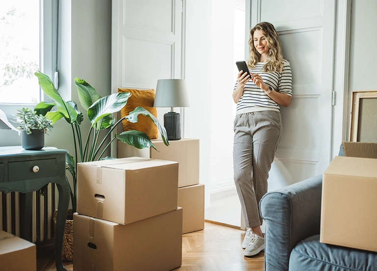 Mature woman with moving boxes in new home